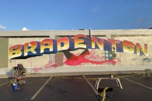 artist painting giant flamingo using a doodle grid method