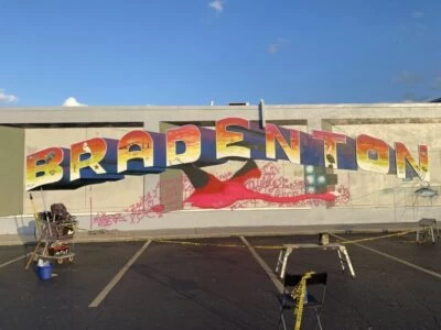 artist painting giant flamingo using a doodle grid method
