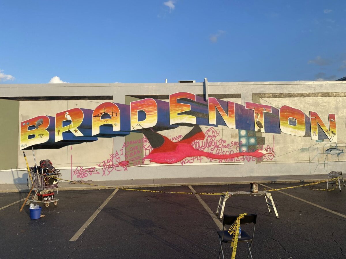 artist painting giant flamingo using a doodle grid method