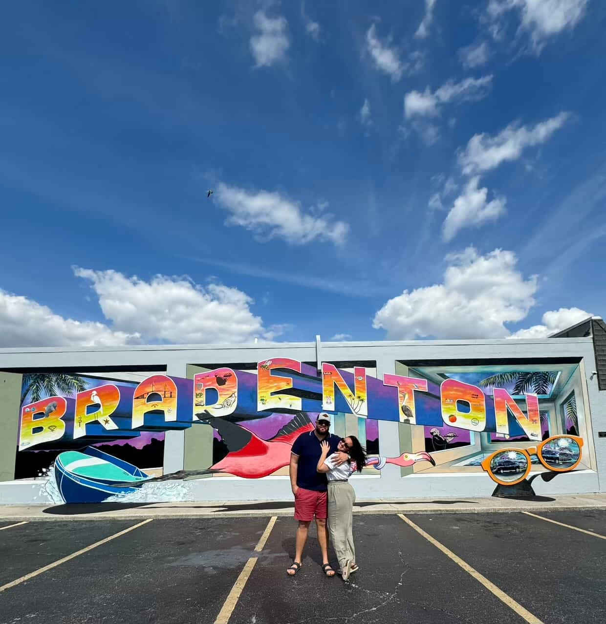 couple takes photo at Bradenton Mural
